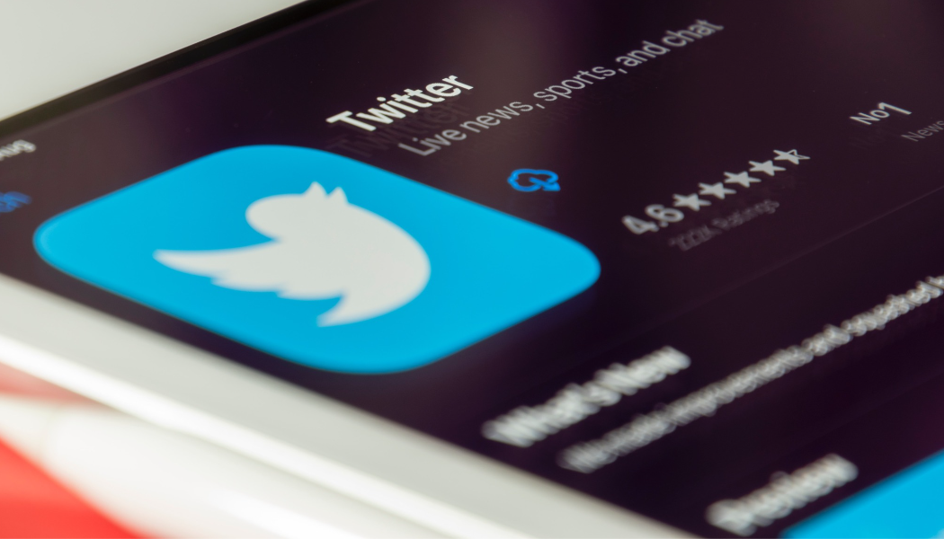 An photograph of a smartphone shows the Twitter app in the App Store